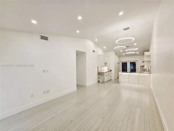 a large kitchen with stainless steel appliances a stove a sink dishwasher and a fireplace with wooden floor
