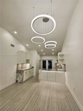 a kitchen with kitchen island a sink stainless steel appliances and cabinets