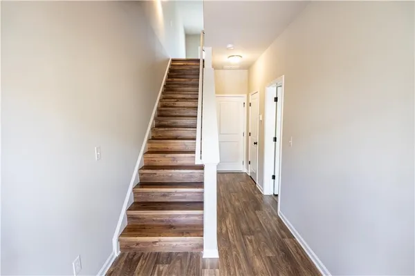 a view of a hallway with wooden floor and entryway
