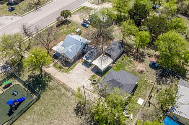 an aerial view of a house with a yard basket ball court and outdoor seating