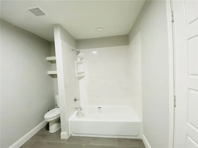 a bathroom with a bathtub and a toilet