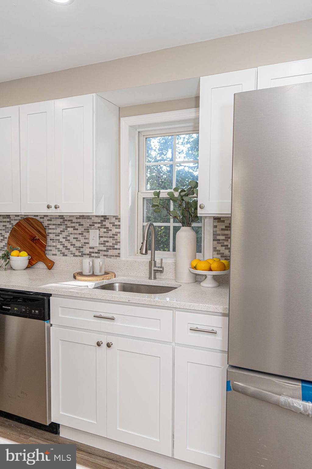 514 Holly Hunt Road Middle River, MD 21220 - Photo 13 of 32 a kitchen with stainless steel appliances granite countertop a sink and a white wooden cabinets