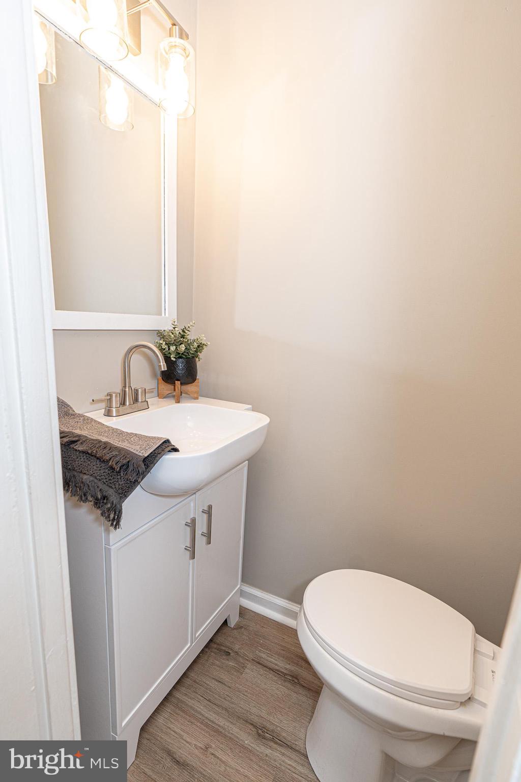 514 Holly Hunt Road Middle River, MD 21220 - Photo 16 of 32 a bathroom with a sink a toilet and mirror