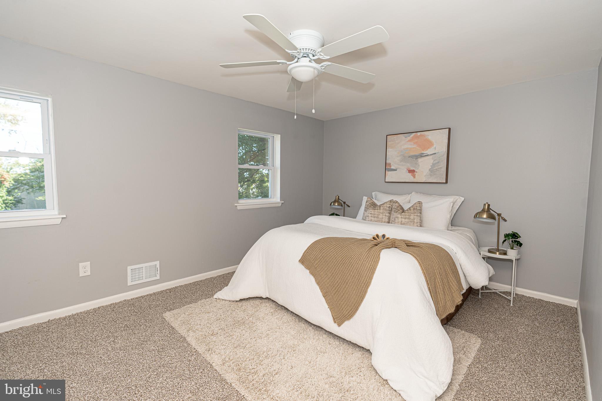 514 Holly Hunt Road Middle River, MD 21220 - Photo 17 of 32 a spacious bedroom with a white bed and a chandelier