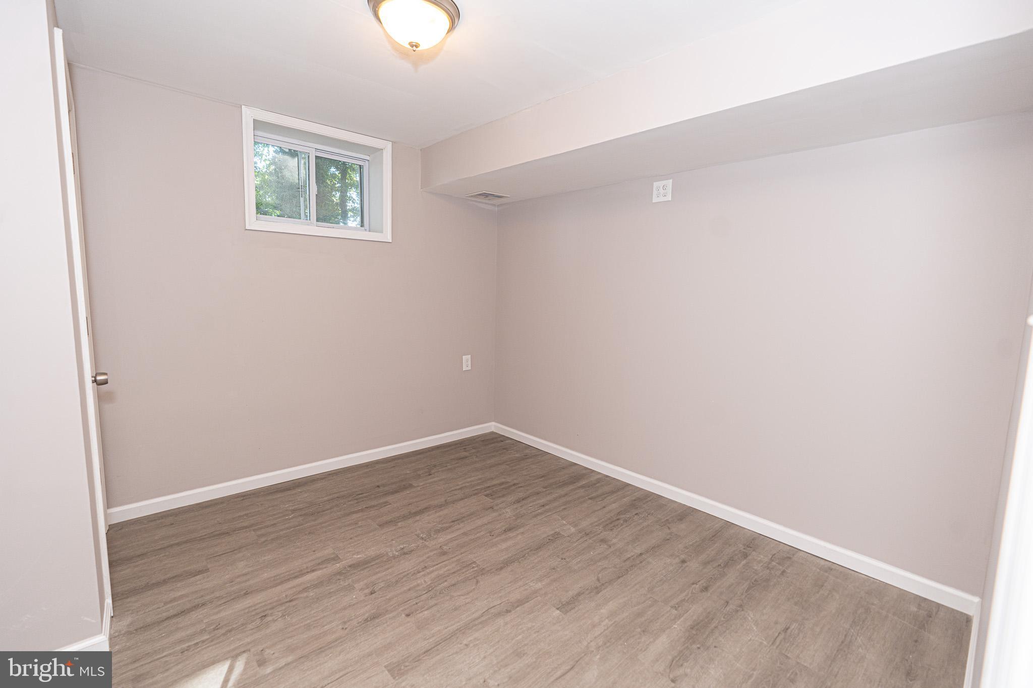 514 Holly Hunt Road Middle River, MD 21220 - Photo 22 of 32 an empty room with wooden floor and windows