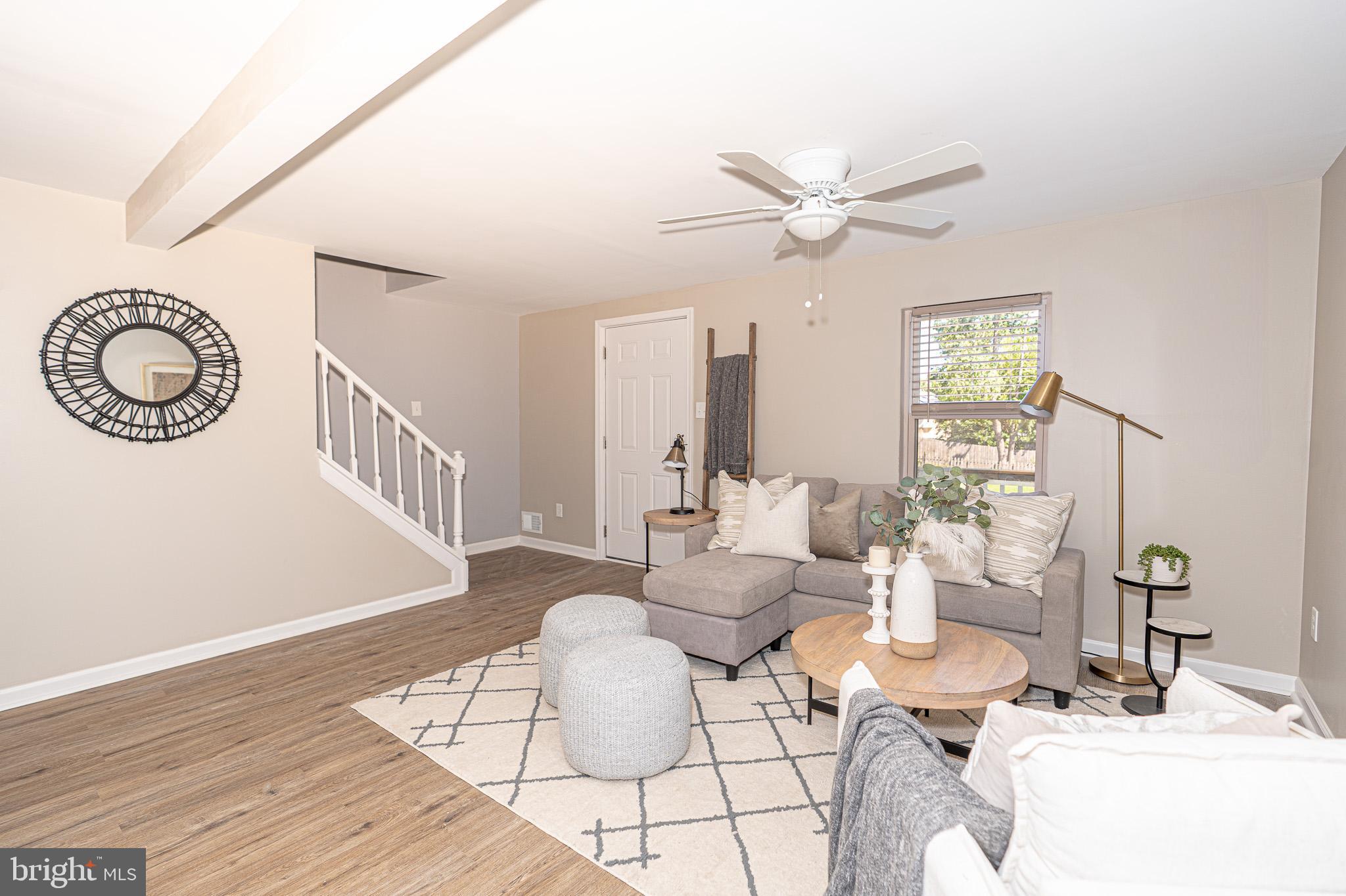 514 Holly Hunt Road Middle River, MD 21220 - Photo 5 of 32 a living room with furniture a table and a chandelier