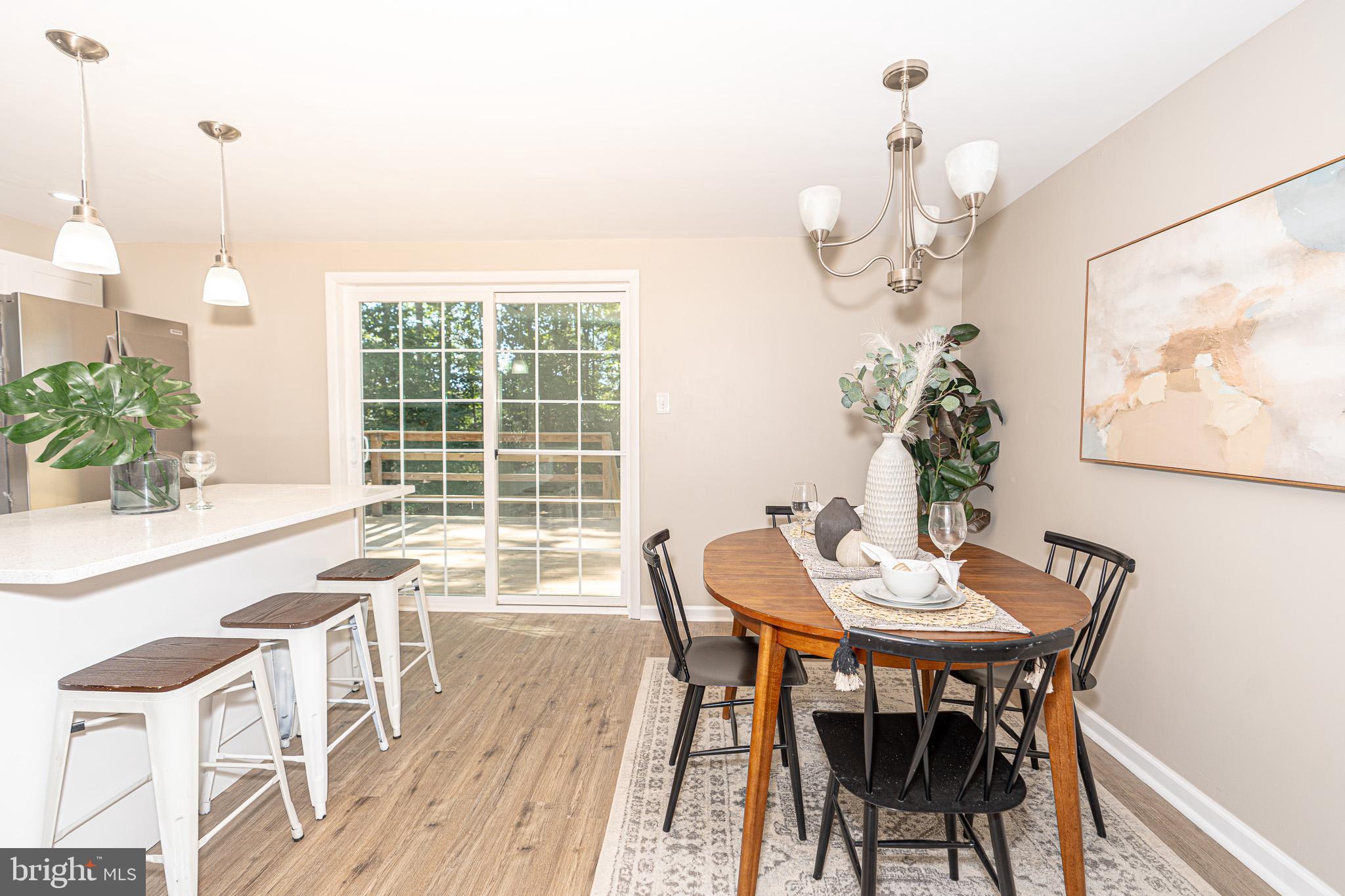 514 Holly Hunt Road Middle River, MD 21220 - Photo 6 of 32 a dining room with furniture a chandelier and wooden floor