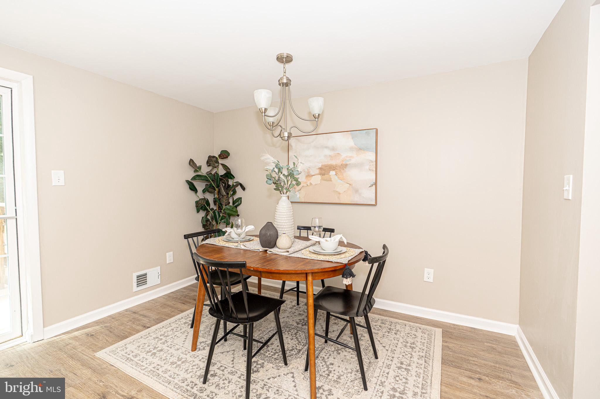 514 Holly Hunt Road Middle River, MD 21220 - Photo 7 of 32 a view of a dining room with furniture and wooden floor
