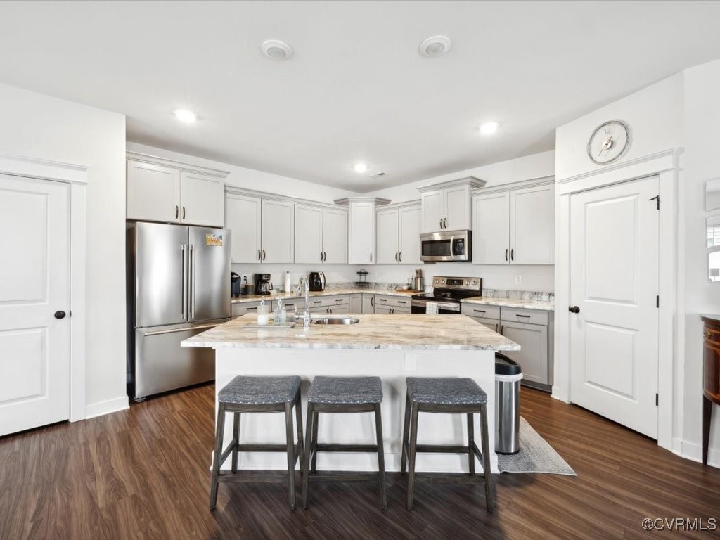3232 Gannet Lane Midlothian, VA 23112 - Photo 17 of 48 a kitchen with a dining table chairs refrigerator and cabinets