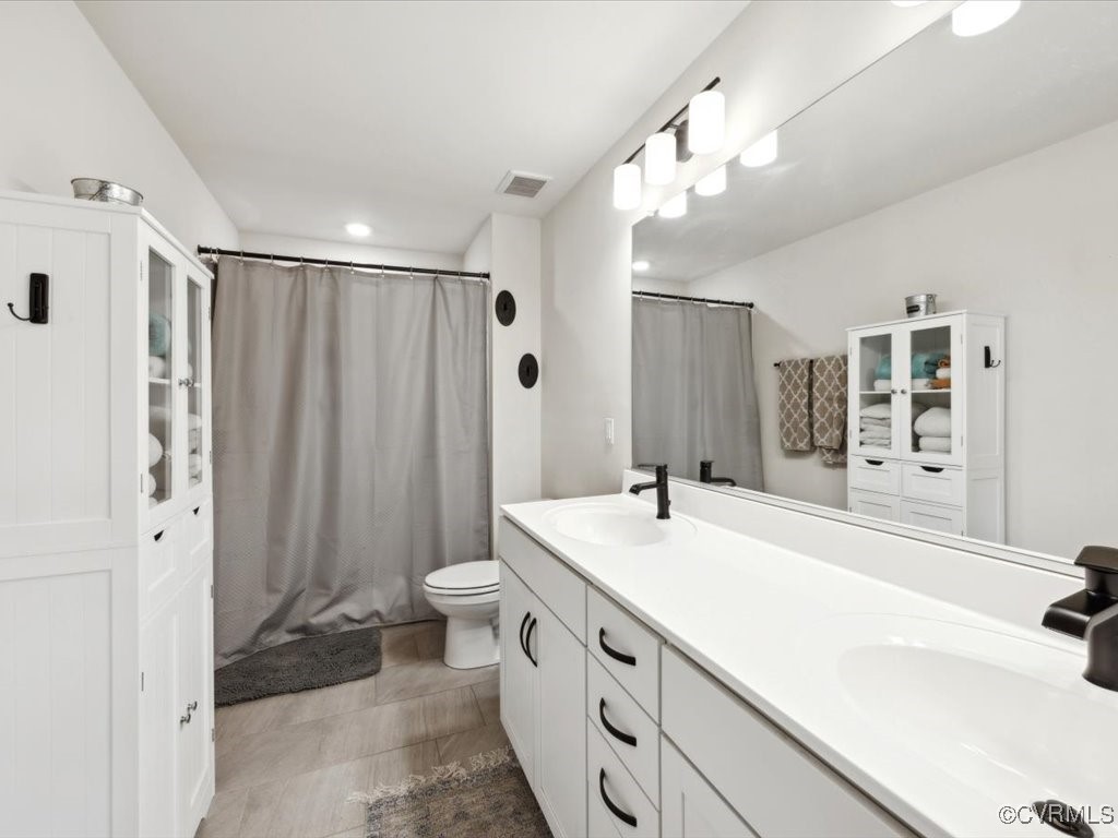 3232 Gannet Lane Midlothian, VA 23112 - Photo 25 of 48 a spacious bathroom with a sink a toilet a mirror a vanity and shower