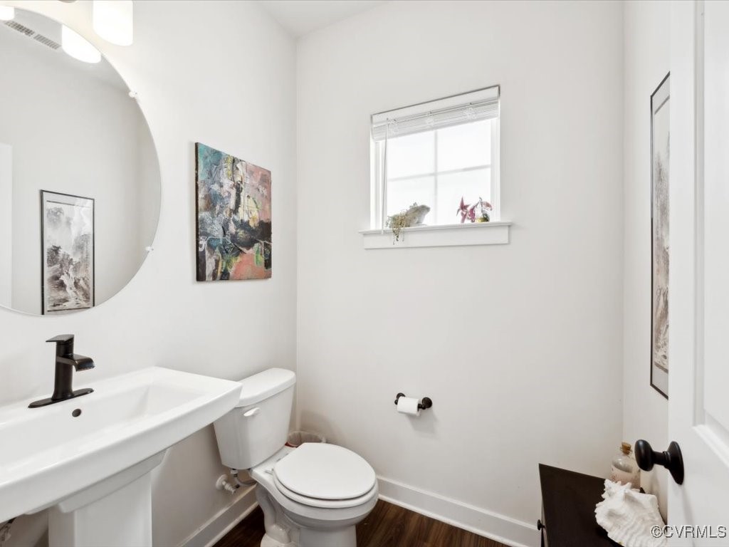 3232 Gannet Lane Midlothian, VA 23112 - Photo 32 of 48 a white toilet sitting next to a bathroom sink