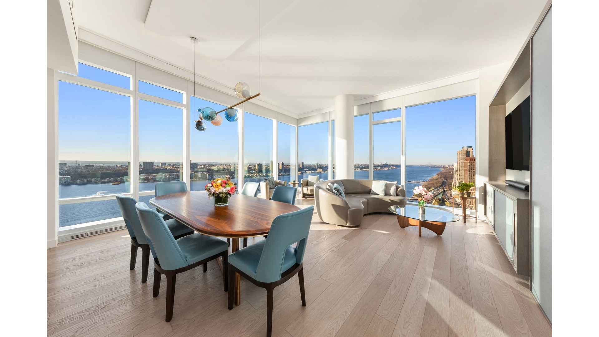 30 Riverside Boulevard, Unit 36B Manhattan, NY 10069 - Photo 1 of 27 a dining room with furniture and a floor to ceiling window