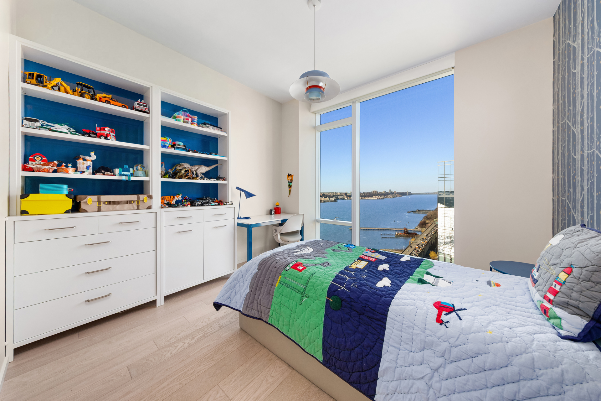 30 Riverside Boulevard, Unit 36B Manhattan, NY 10069 - Photo 11 of 27 a bed room with a bed and a book shelf