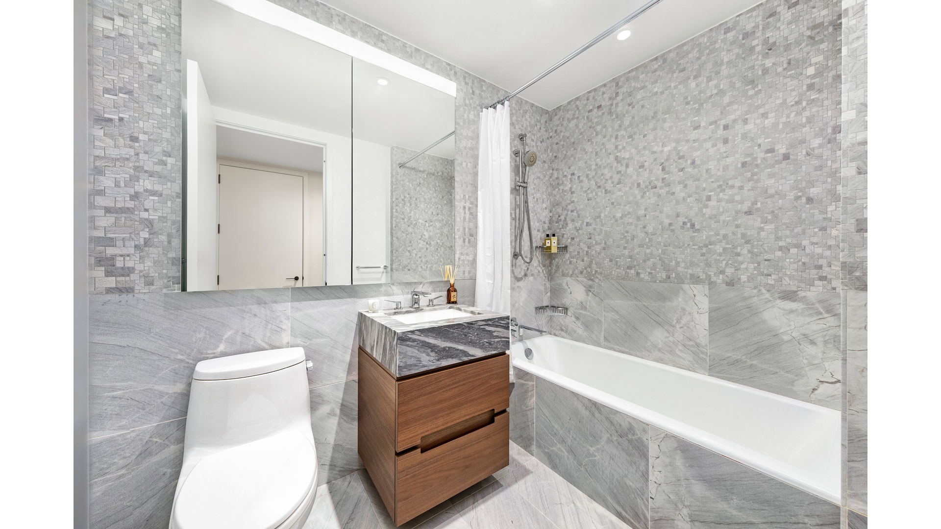30 Riverside Boulevard, Unit 36B Manhattan, NY 10069 - Photo 12 of 27 a bathroom with a granite countertop sink a toilet and bathtub