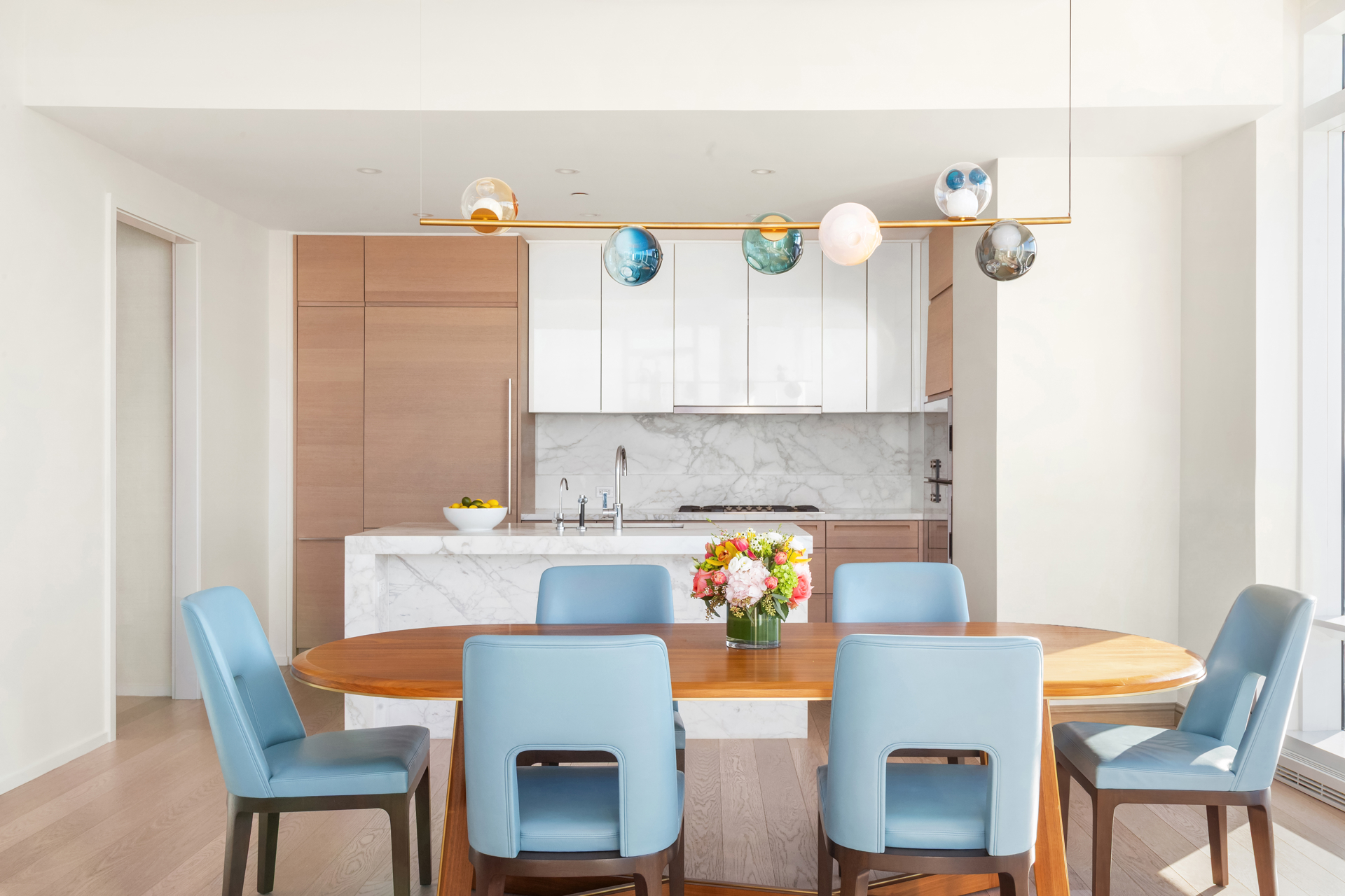 30 Riverside Boulevard, Unit 36B Manhattan, NY 10069 - Photo 3 of 27 a kitchen with a dining table chairs and a refrigerator