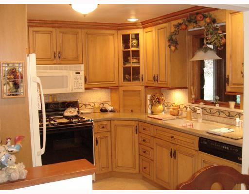 279 McWilliams Road Level Green, PA 15085 - Photo 5 of 16 Kitchen. 11 x 10 Custom Designed Kitchen Features Porcelain Tile Flooring, Overhead LIghting, Recessed Lighting, Glazed Cabinets, Corian Counter Tops, Ceramic Tile Back Splash, Dishwasher, Gas Stove, Mocrowave and Refrigerator!