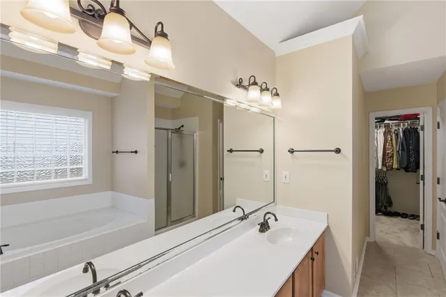 a bathroom with a tub sink and mirror