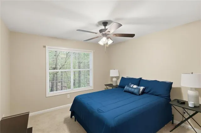 a bed sitting in a bedroom next to a window