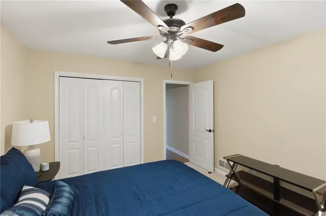 a living room with wooden floor and ceiling fan