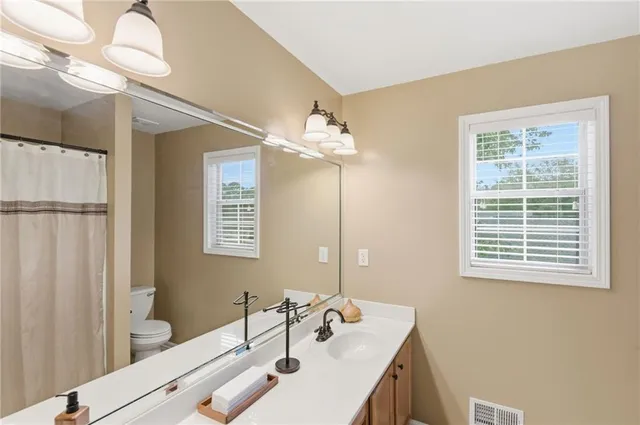 a bathroom with a sink a vanity and a mirror