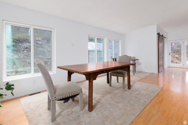 3902 Beaver Creek Road Kamas, UT 84036 - Photo 9 of 33 Dining room featuring a barn door and light wood-type flooring