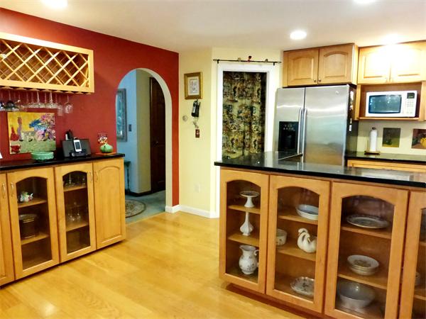 69 Concord Road Acton, MA 01720 - Photo 3 of 25 a view of a kitchen with stainless steel appliances and furniture