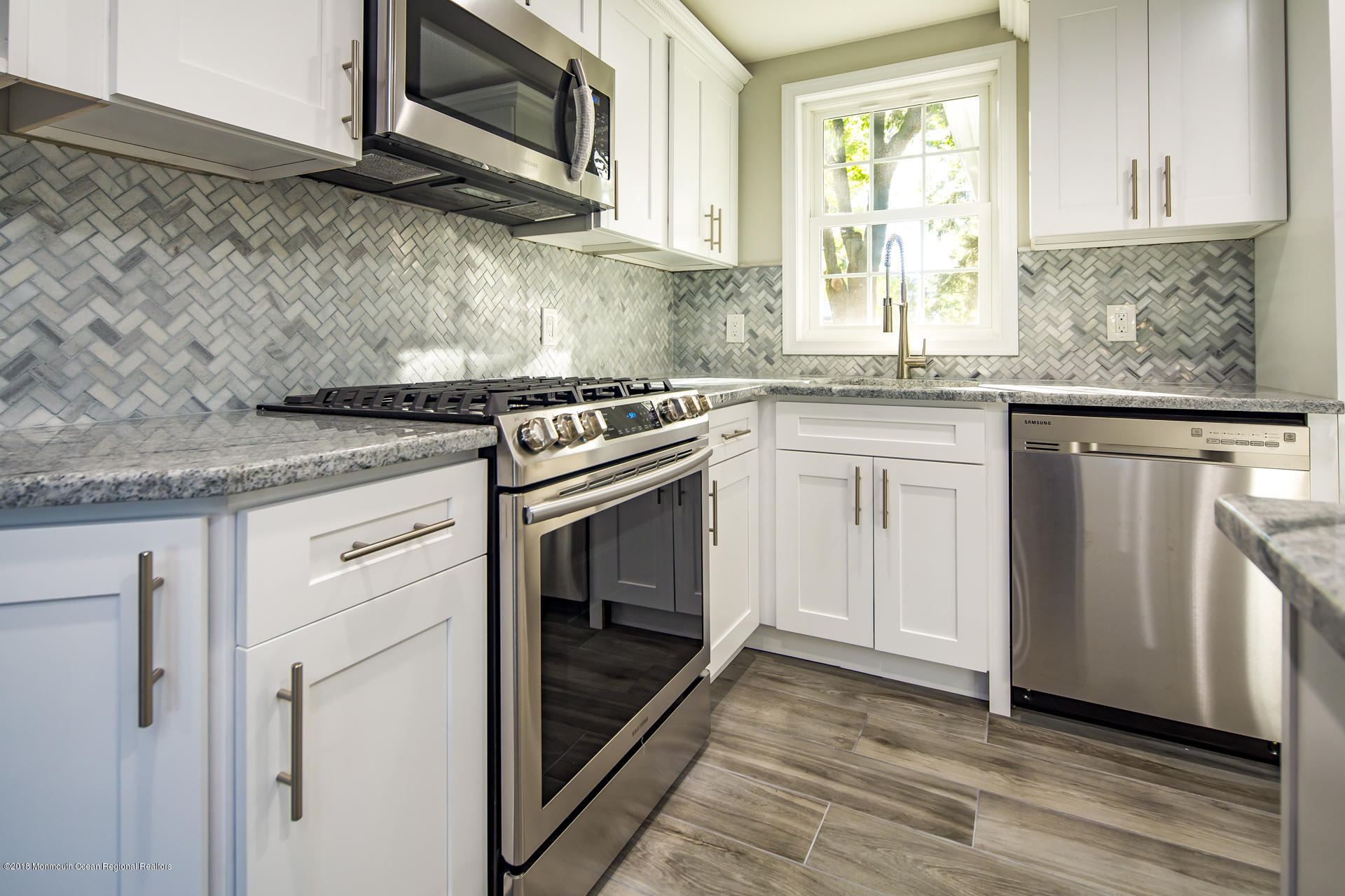 584 Colts Neck Road Freehold, NJ 07728 - Photo 12 of 29 a kitchen with granite countertop cabinets stainless steel appliances and sink