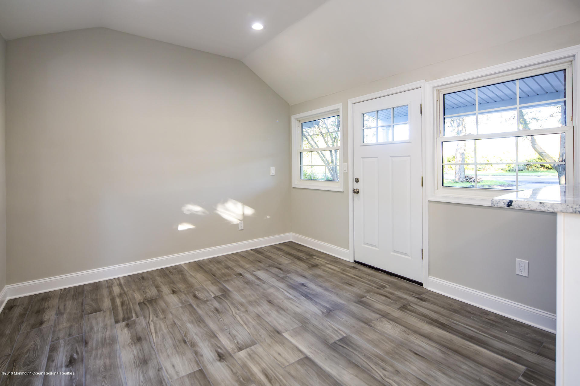 584 Colts Neck Road Freehold, NJ 07728 - Photo 13 of 29 an empty room with wooden floor and windows