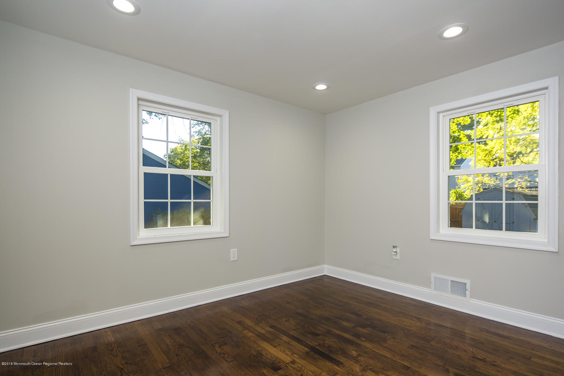 584 Colts Neck Road Freehold, NJ 07728 - Photo 17 of 29 a view of an empty room with wooden floor and a window