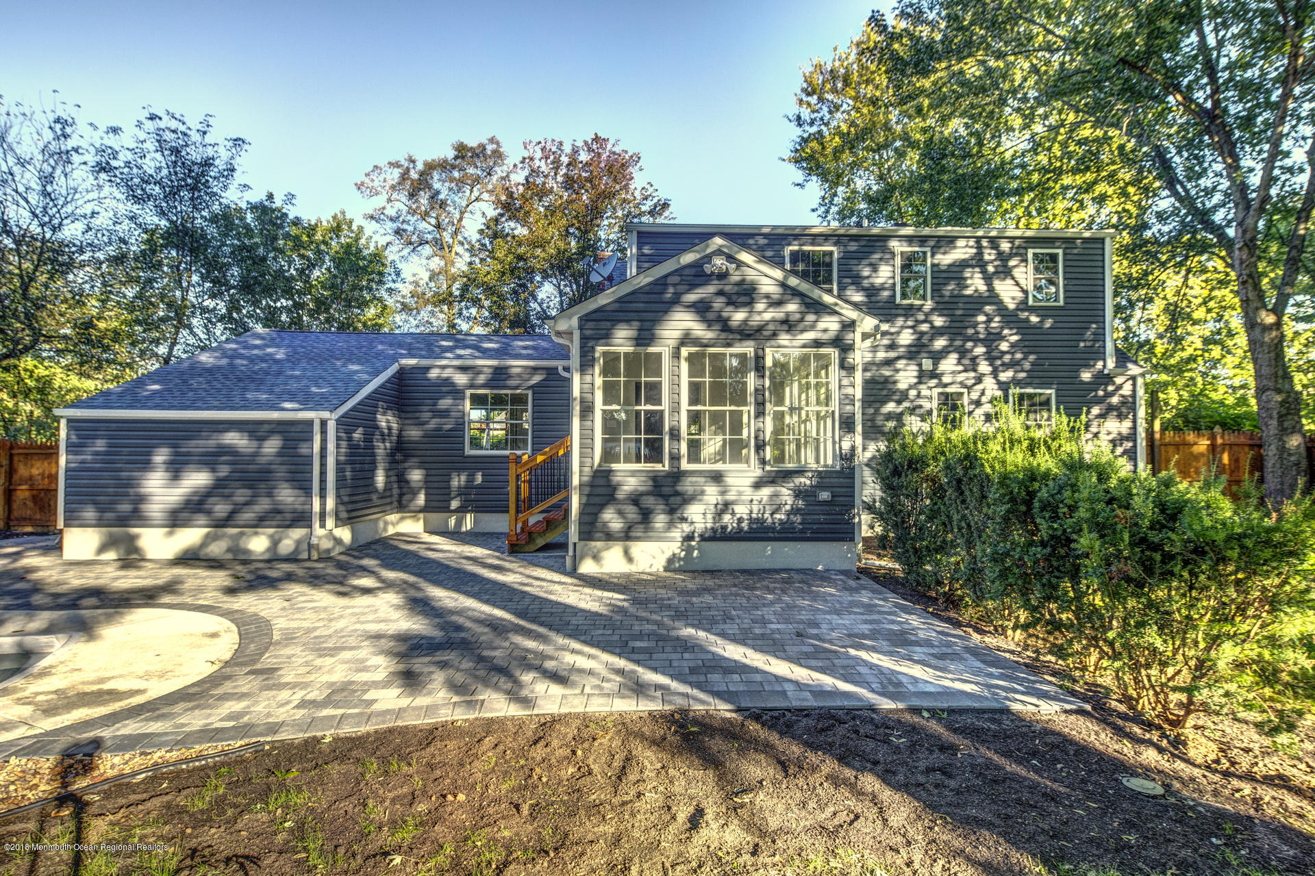 584 Colts Neck Road Freehold, NJ 07728 - Photo 24 of 29 a front view of a house with a garden