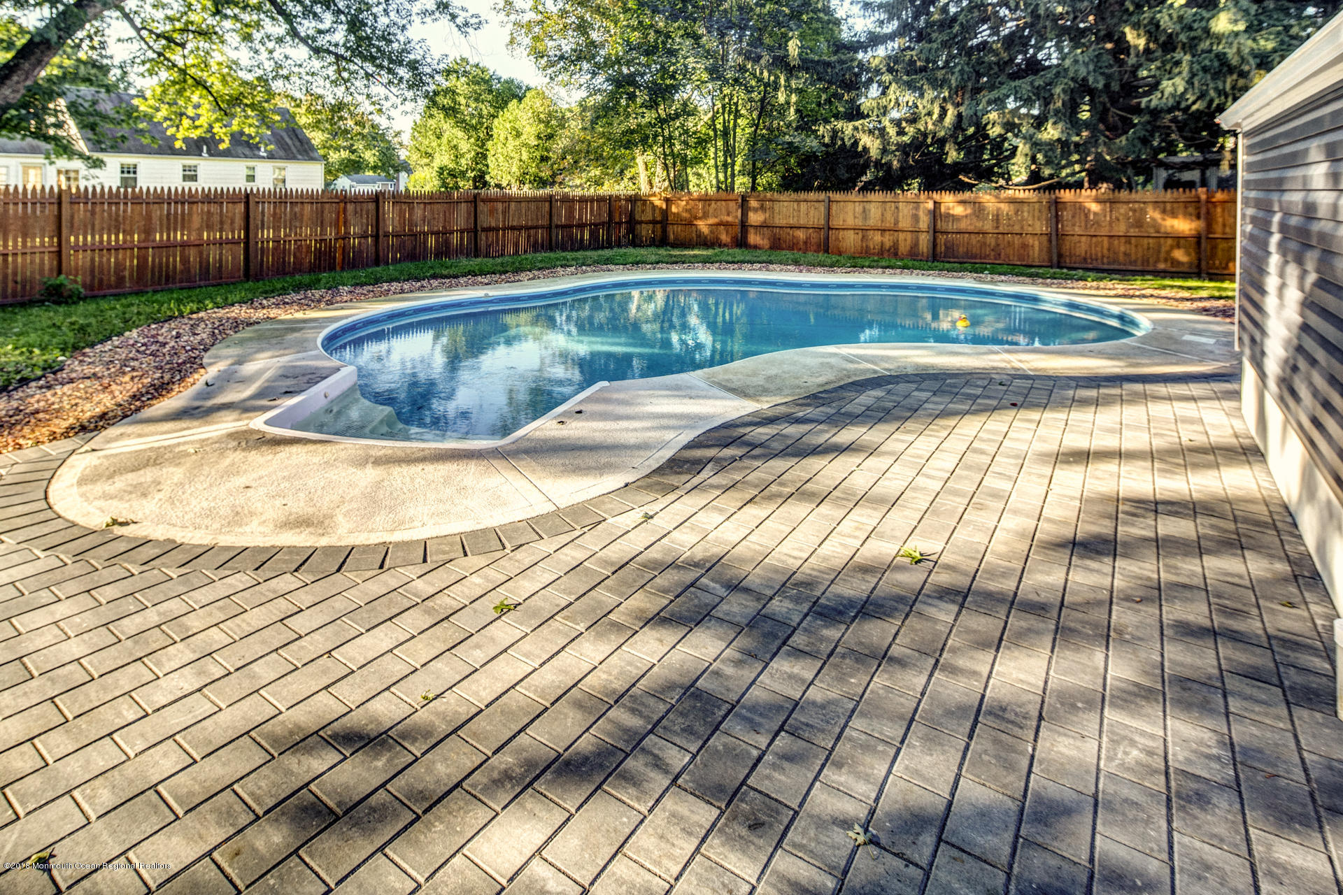 584 Colts Neck Road Freehold, NJ 07728 - Photo 26 of 29 a view of backyard with swimming pool and wooden fence