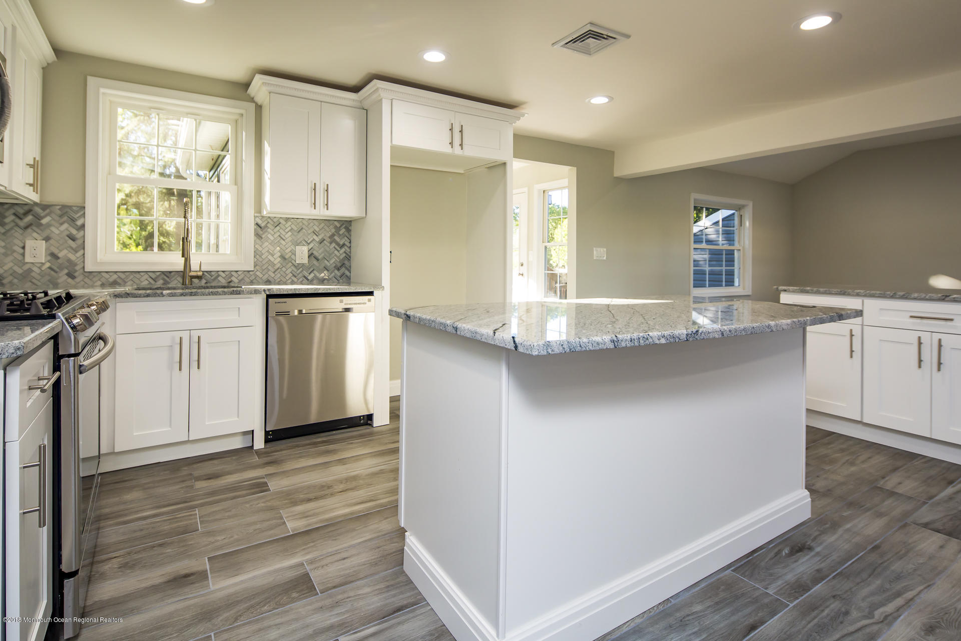 584 Colts Neck Road Freehold, NJ 07728 - Photo 8 of 29 a kitchen with stainless steel appliances granite countertop a sink and a refrigerator