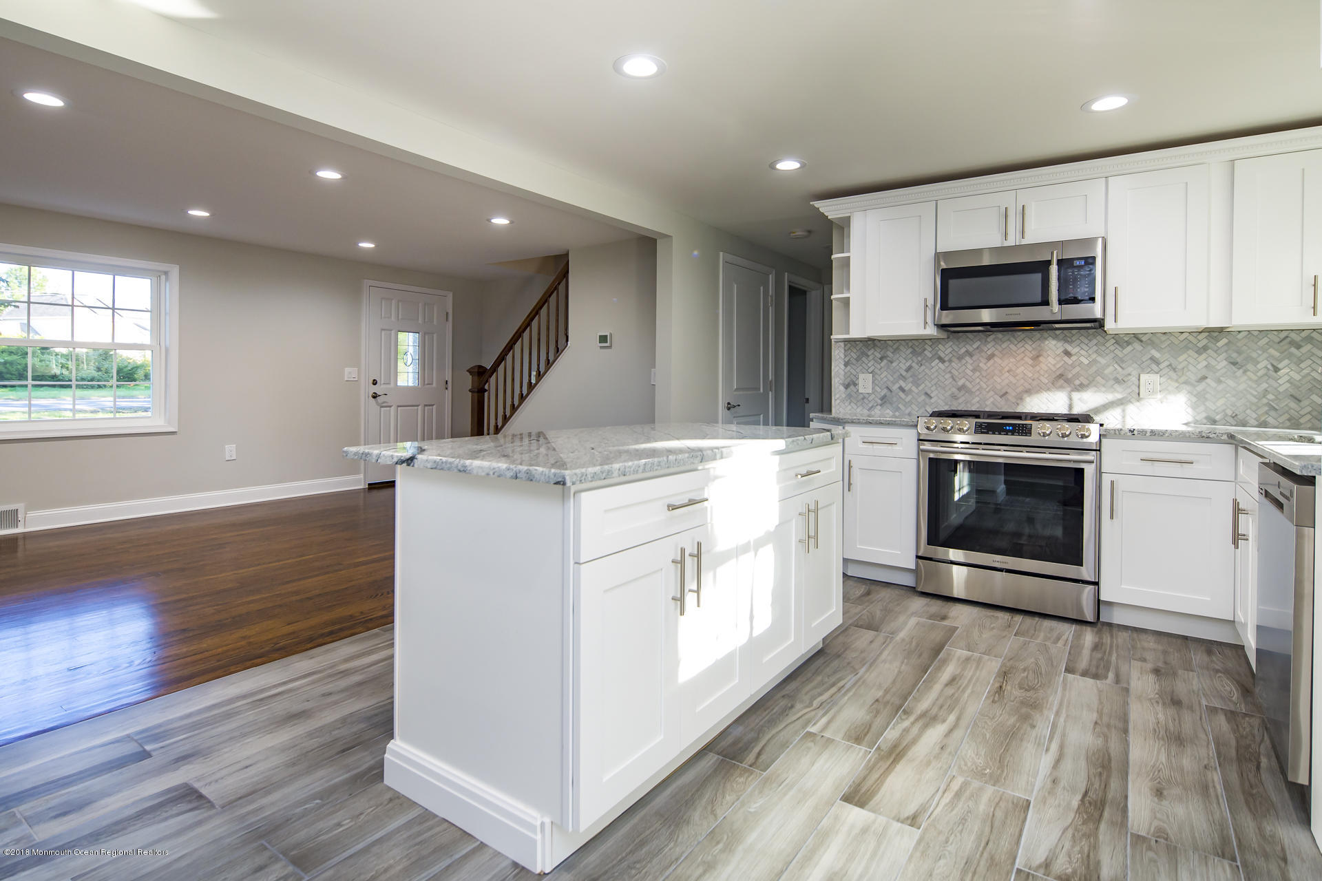 584 Colts Neck Road Freehold, NJ 07728 - Photo 10 of 29 a kitchen with stainless steel appliances granite countertop a stove a sink and a microwave