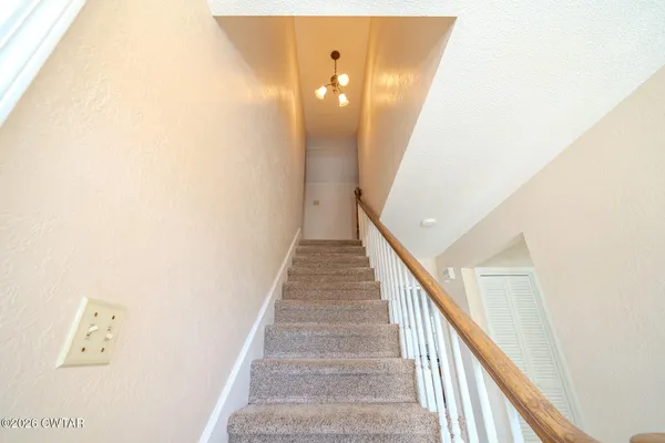 a view of a hallway with staircase