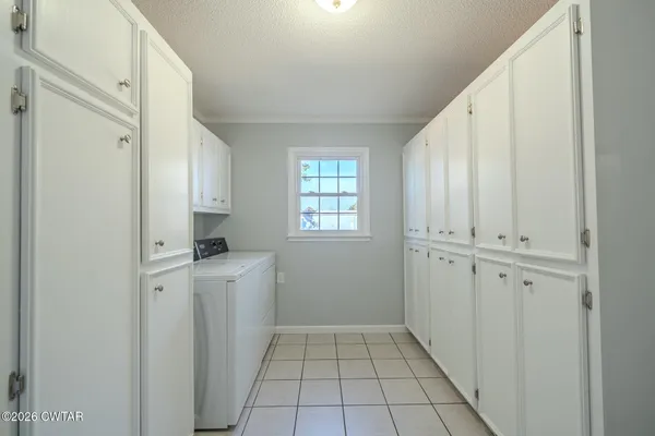a view of a kitchen with white cabinets and white appliances