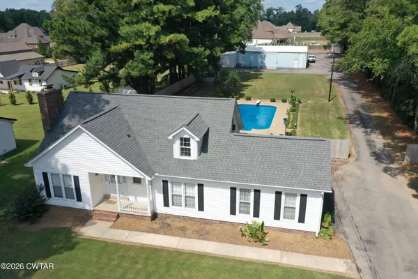 an aerial view of a house with a yard