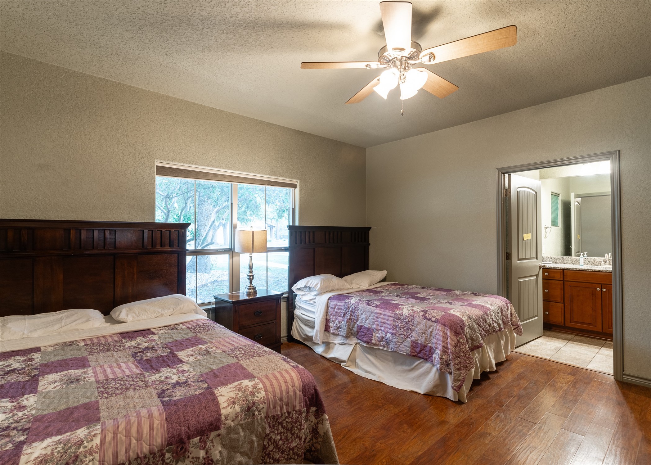 72 Stepping Stone Lane Concan, TX 78838 - Photo 11 of 25 a bedroom with two beds and a chandelier