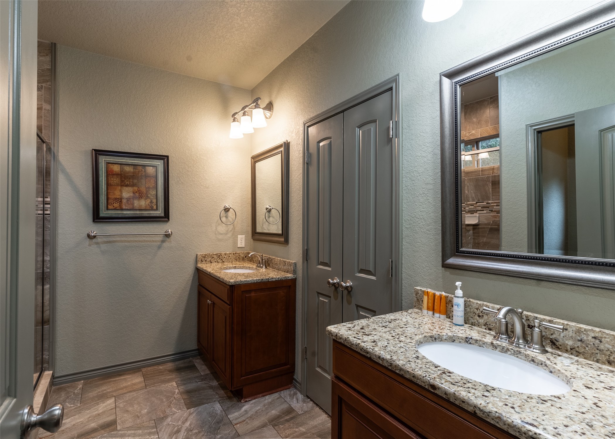 72 Stepping Stone Lane Concan, TX 78838 - Photo 12 of 25 a bathroom with a granite countertop sink and mirror