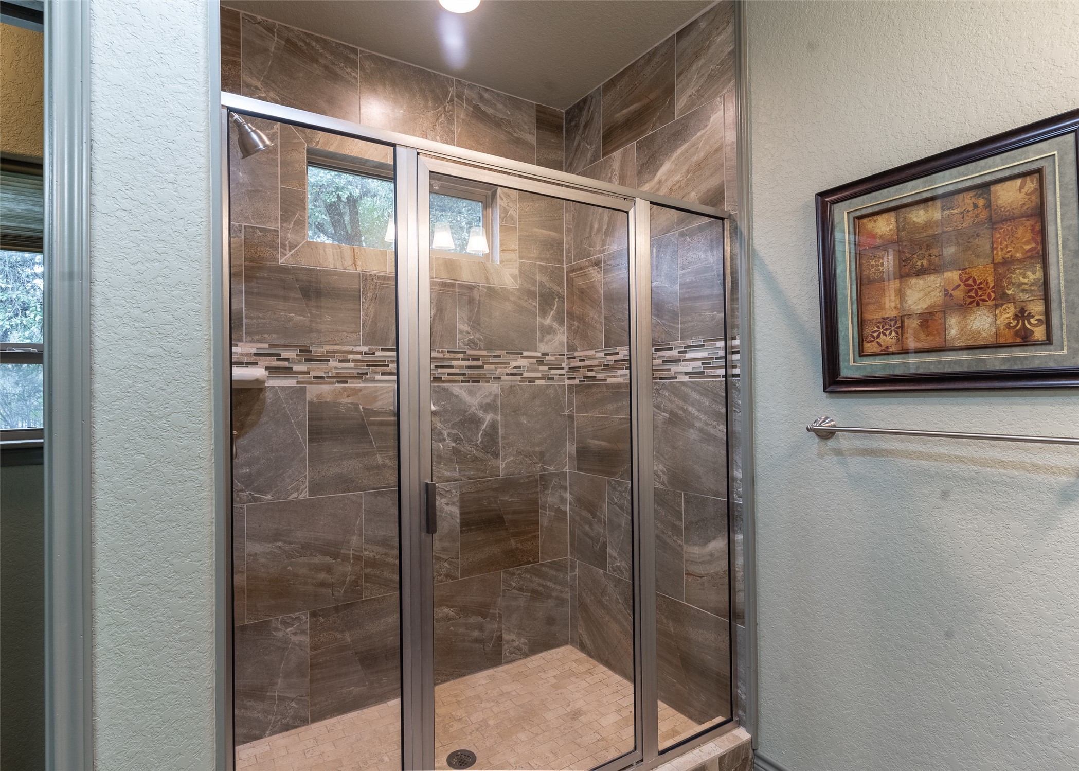72 Stepping Stone Lane Concan, TX 78838 - Photo 13 of 25 a bathroom with a glass shower door