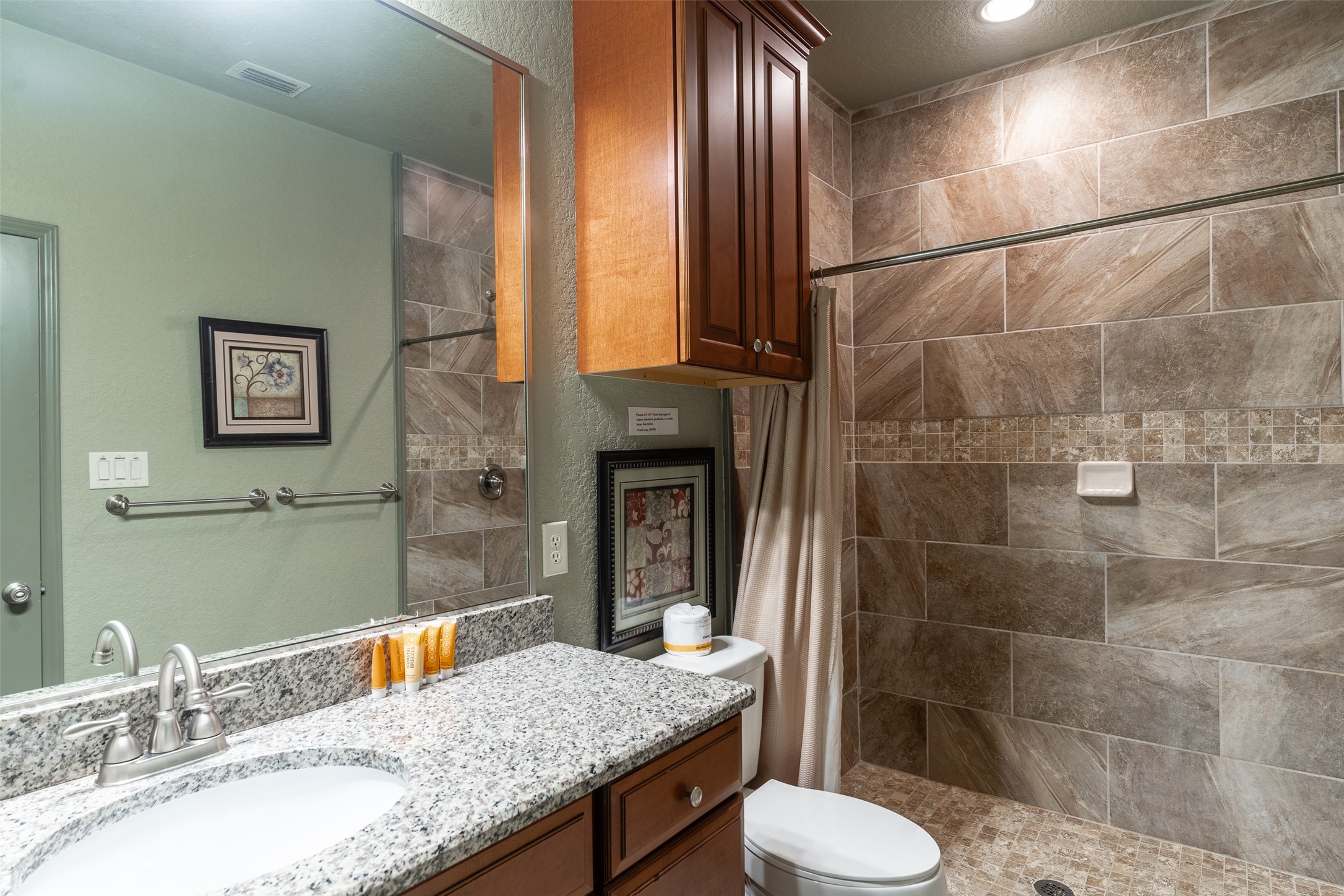 72 Stepping Stone Lane Concan, TX 78838 - Photo 14 of 25 a bathroom with a granite countertop sink toilet and shower