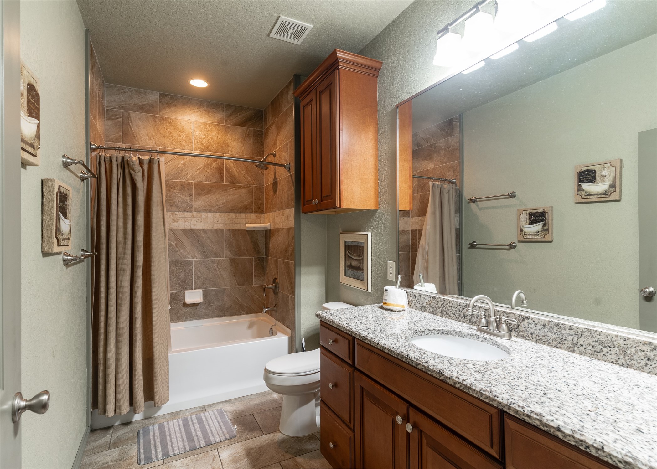 72 Stepping Stone Lane Concan, TX 78838 - Photo 17 of 25 a bathroom with a granite countertop sink a toilet a mirror and shower