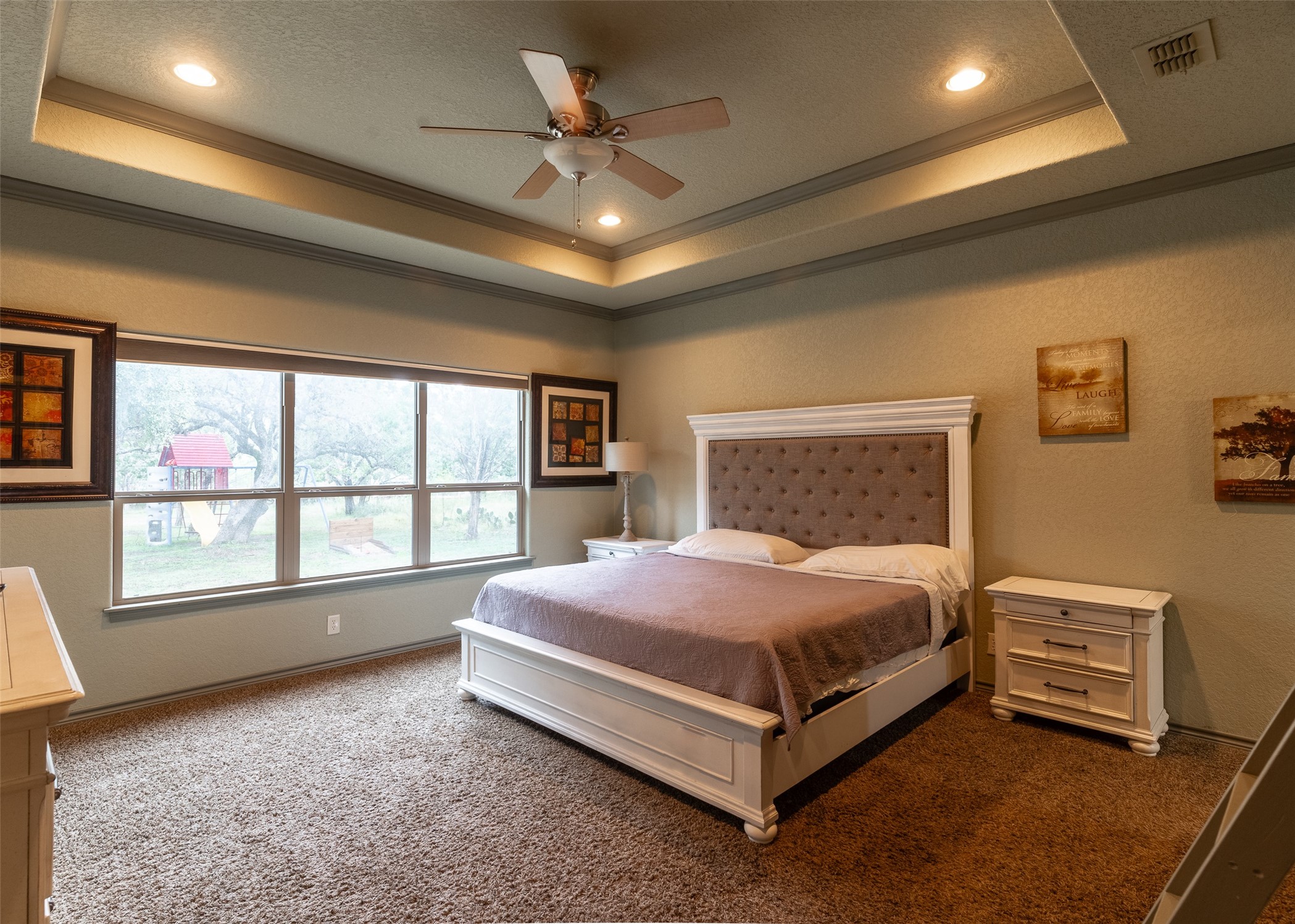 72 Stepping Stone Lane Concan, TX 78838 - Photo 7 of 25 a spacious bedroom with a bed and a ceiling fan