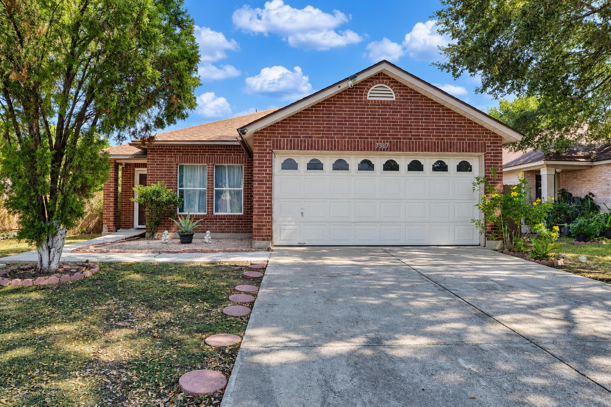 7317 Marble Ridge Drive Austin, TX 78747 - Photo 7 of 30 Classic brick craftsmanship defines this inviting exterior fronted by a wide concrete driveway.