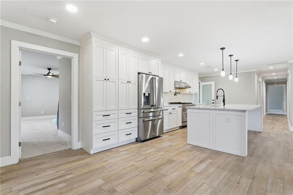 1625 Lake Road Hiram, GA 30141 - Photo 12 of 58 a kitchen with white cabinets and stainless steel appliances