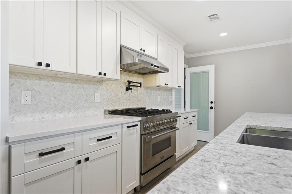 1625 Lake Road Hiram, GA 30141 - Photo 14 of 58 a kitchen with stainless steel appliances white cabinets and a stove