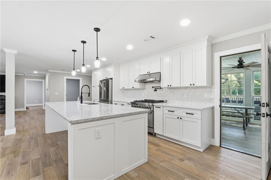 1625 Lake Road Hiram, GA 30141 - Photo 15 of 58 a kitchen with white cabinets appliances and wooden floor