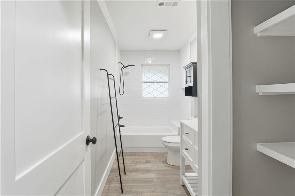 1625 Lake Road Hiram, GA 30141 - Photo 24 of 58 a bathroom with a granite countertop toilet tub and a shower