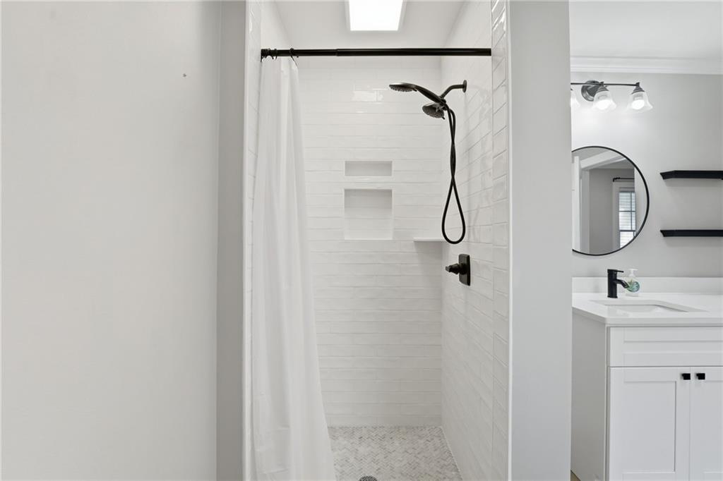 1625 Lake Road Hiram, GA 30141 - Photo 39 of 58 a bathroom with a granite countertop shower sink and mirror