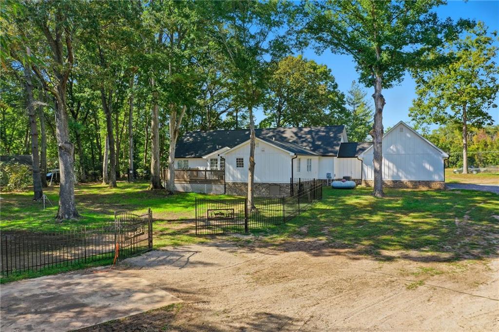 1625 Lake Road Hiram, GA 30141 - Photo 49 of 58 a view of a house with a yard and a large tree