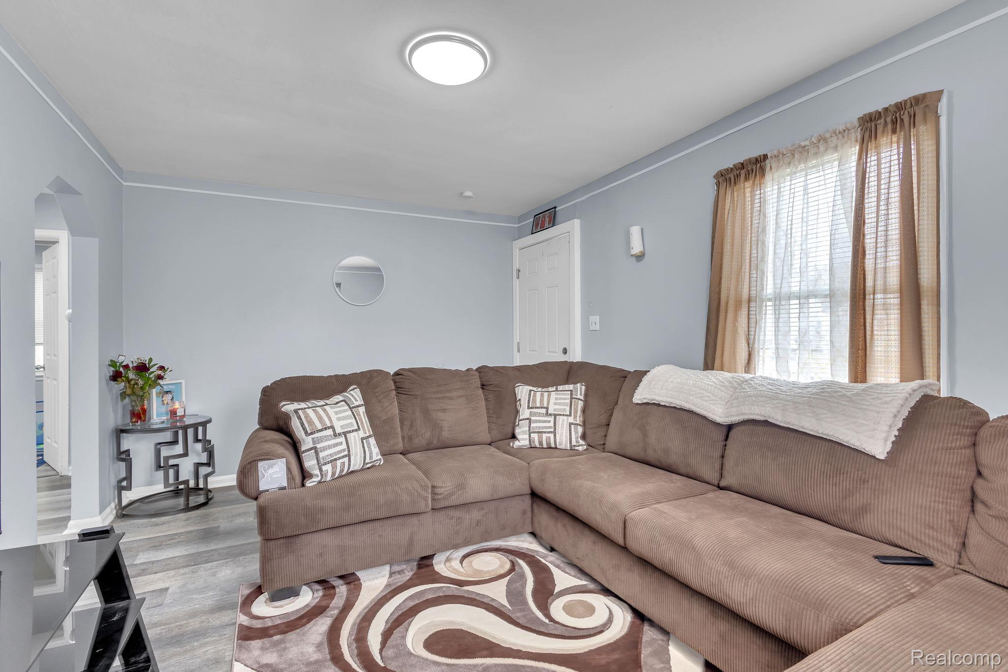 8401 Fielding Street Detroit, MI 48228 - Photo 6 of 34 Living area with wood finished floors and crown molding